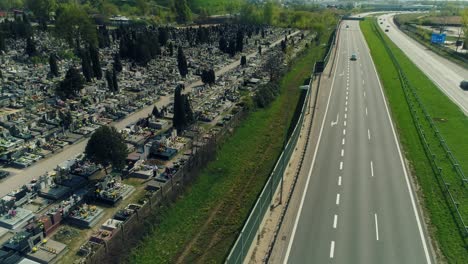 Aerial-view-of-a-cemetery-by-multiple-lane-highway
