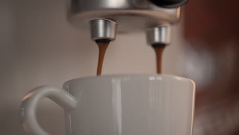 Close-up-of-making-espresso-coffee-that-is-poured-into-a-cup