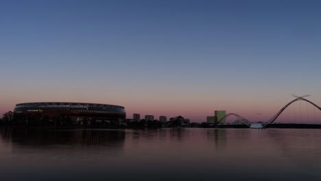 Day-to-night-time-lapse-of-a-stadium-by-the-Swan-river-in-Perth,-Western-Australia