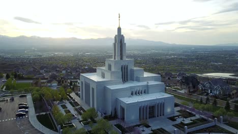 Drone-shot-panning-up-and-revealing-the-LDS-Draper-Temple-at-sunset-with-the-Salt-Lake-Valley-in-the-background