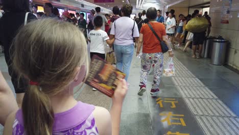 Xian,-China---July-2019-:-Culte-little-Caucasian-girl-walking-with-her-mother-in-the-underground-passage-to-the-tube-station