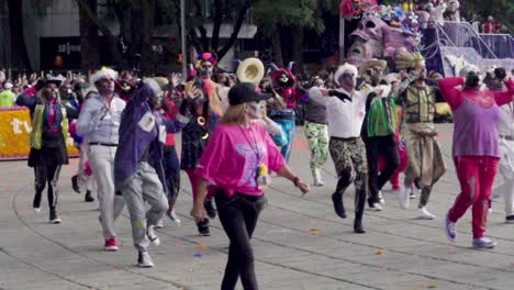 Mexico-City,-Mexico---October-27th,-2018:-Day-of-the-Dead,-Crowd-of-people-in-skull-costume-dancing-during-the-parade-Día-de-Muertos---Day-of-the-Dead-in-Mexico