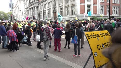 Protesters-block-the-road-near-Westminster-at-the-Extinction-Rebellion-protests-in-London,-UK