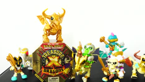 Camera-slowly-zooming-into-the-Treasure-X-Dragons-Gold-toy-box-with-mini-figures-surrounding-it