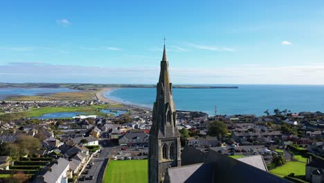 Aerial-flying-over-cross-church-in-Waterford,-Ireland,-dolly-backward