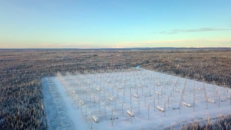Aerial,-drone-shot,-over-the-HAARP-antenna-array,-on-a-cold-and-sunny,-winter-day,-in-Gakona,-Alaska,-USA