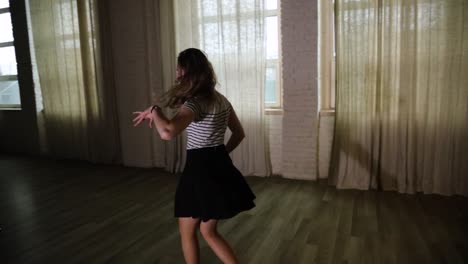 Teenage-girl-spinning-and-dancing-in-the-studio-slow-motion