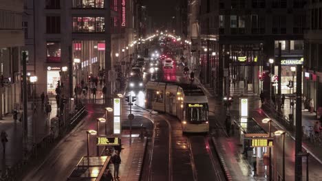 Busy-intersection-and-tram-stop,-Friedrichstrasse-Berlin-on-a-wet-night