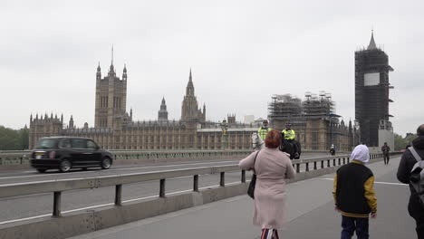 Two-police-officers-on-horses-walk-across-a-near-deserted-Westminster-Bridge-and-past-the-Houses-of-Parliament-during-the-Coronavirus-outbreak