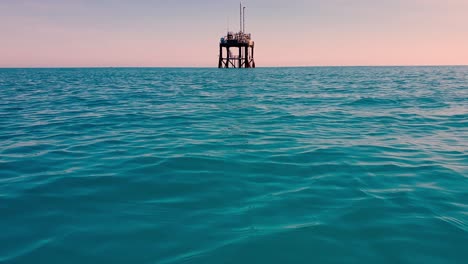Approaching-an-abandoned-offshore-oil-platform-or-oil-rig-in-open-sea