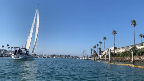 sail-boat-traveling-through-a-harbor