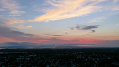 An-aerial-time-lapse-over-a-suburban-neighborhood-at-sunset