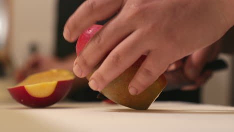 Person-Cutting-A-Fresh-Ripe-Sweet-Mango-Using-A-Sharp-Knife