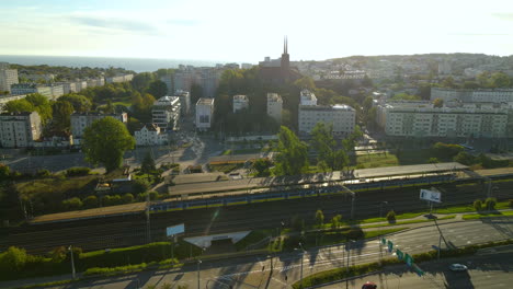 Aerial-dolly-slider-of-train-rails-and-cheap-housing-complex-in-background-in-Gdynia,Poland