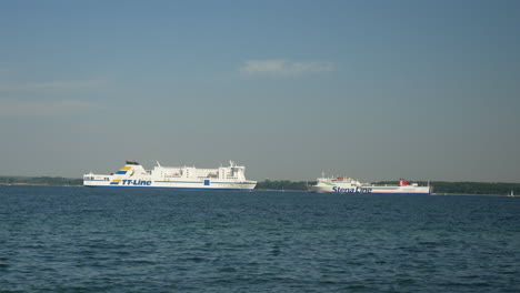 Wide-shot-of-two-german-ferries-crossing-baltic-sea-during-sunny-day-in-Travemünde,Germany