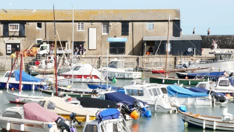 Moored-boats-move-back-and-forth-in-a-calm-Lyme-regis-harbour