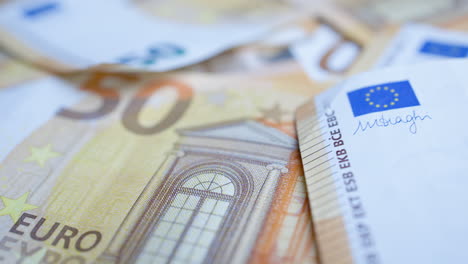 Close-up-of-details-on-50-euro-paper-money-bills---focus-pull,-tilt-shot