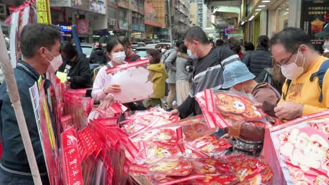 People-shop-for-Chinese-New-Year-decorative-ornament-goods-and-gifts-at-a-street-stall-ahead-of-the-Lunar-Chinese-New-Year-festivities-and-celebrations-in-Hong-Kong