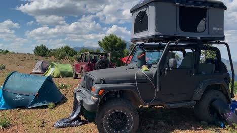 Adventure-camping-with-4x4-jeep-in-mountains,-fun-expeditions-in-the-countryside