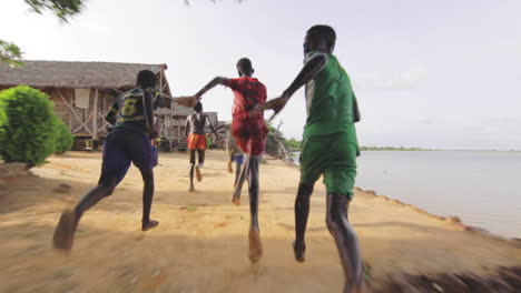 Soccer-fan-african-black-kids-running-at-Senegal-lake-shores