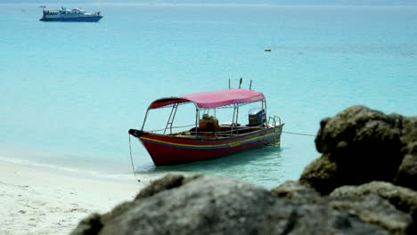 Boat-Taxi-Moored-On-White-Sand-Beach-Of-Perhentian-Islands-In-Malaysia