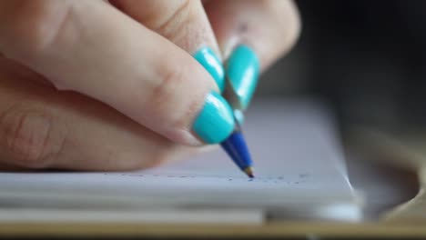 woman-hand-writing-with-pen-close-up