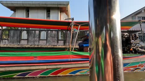 POV-Riding-On-Longtail-Boat-With-Another-Passing-By-On-Khlong-Bangkok-Yai-Canel-Waterways-With-High-Sun-In-The-Sky