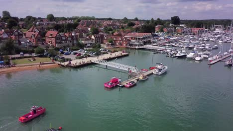 Drone-shot-of-pink-ferry-arriving-to-pickup-passengers-on-a-cloudy-summers-day-in-Hamble