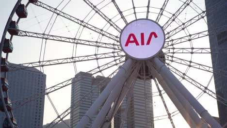 Closeup-Hong-Kong-central-Ferris-wheel-AIA-logo-advertised,-China