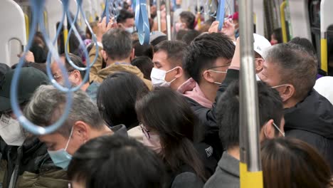 Commuters-ride-on-a-crowded-MTR-subway-train-line-during-the-Chinese-Lunar-New-Year-in-Hong-Kong