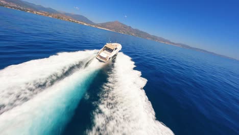 FPV-aerial-following-a-luxury-yacht-sailing-off-the-coast-of-Marbella,-Spain