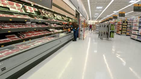Employee-restocking-the-meat-displays-in-an-American-mega-grocery-store