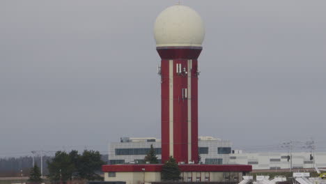 Air-traffic-control-tower-at-Gdansk-Rebiechowo-Airport,-Poland---zoom-out
