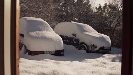 Two-Cars-Under-Fresh-Snow-Parked-Outside-The-Cabin-In-Trondheim,-Norway