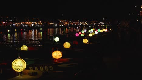 Night-shot-of-Thu-Bon-River-in-Hoi-An,-Vietnam-with-decorated-boats-and-lanterns