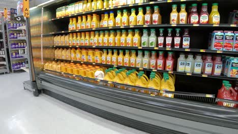 Slowly-passing-the-refrigerated-displays-of-fruit-juice-and-lemonade-in-an-American-mega-grocery-store