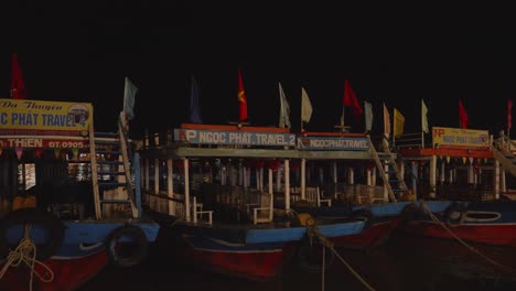 Night-shot-of-boats-moored-at-Thu-Bon-River-waterfront-in-Hoi-An,-Vietnam