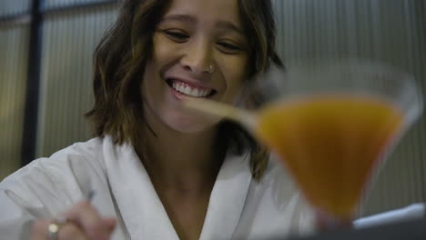 Slow-motion-shot-of-a-beautiful-female-having-breakfast-with-a-glass-of-orange-juice