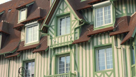 Low-angle-shot-of-exterior-of-the-Normandy-hotel-along-the-seaside-in-Deauville,-France-on-a-sunny-day