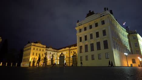Walking-in-front-of-the-Prague-castle-complex-with-people-at-night