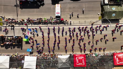 Aerial-view-above-the-Batalla-de-Flores-Parade-in-sunny-Barranquilla,-Colombia---top-down,-drone-shot