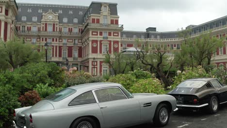 Luxury-vintage-cars-parked-in-front-of-Hotel-du-Palais-at-Biarritz-in-France