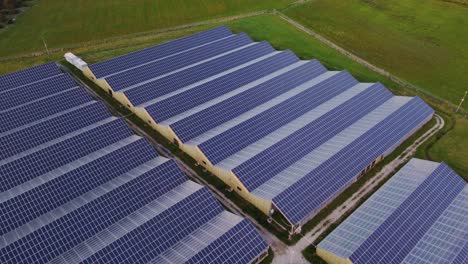 Aerial-view-of-solar-panel-array-of-greenhouse-farm-roofs-during-day-time