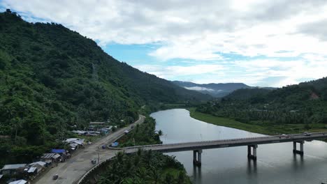 Aerial-view-of-bridge-and-commuting-residents-in-the-town-of-Bato,-Catanduanes,-Philippines
