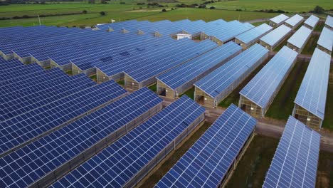 Blue-solar-panel-array-with-thousands-of-solar-panels-on-roofs-of-greenhouses