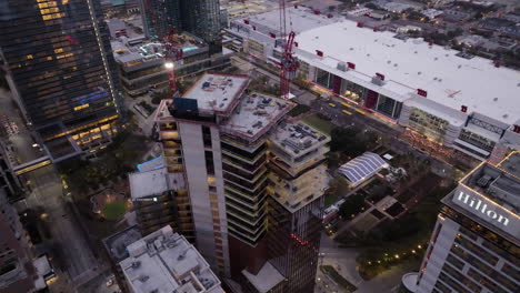 Aerial-view-overlooking-the-Skanska-1550-on-the-green-Construction-site,-in-Houston,-USA---high-angle,-orbit,-drone-shot