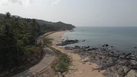 Winding-beach-road-follows-peaceful-coast-of-Koh-Lanta-in-Thailand