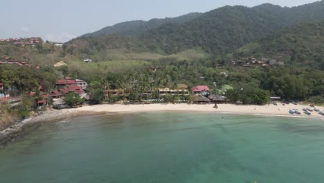 Flight-to-quiet-tourism-beach-in-Kantiang-Bay,-Koh-Lanta-Thailand