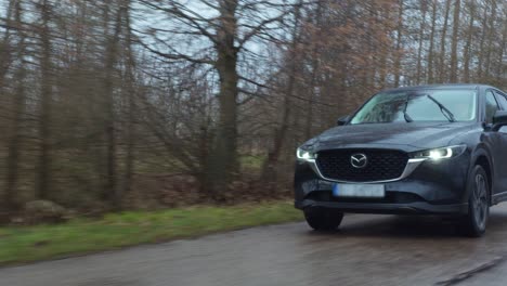 New-modern-SUV-Mazda-cx-30-model-driving-in-European-forest-road