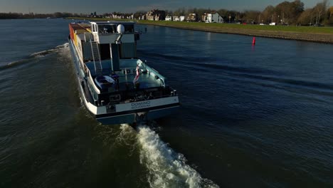 Blue-containership-navigating-through-the-dutch-canals-of-Alblasserdam,-The-Netherlands